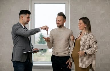 Successful home purchase couple broker key transfer