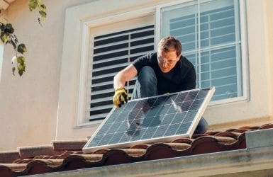 sustainable man lays solar panels