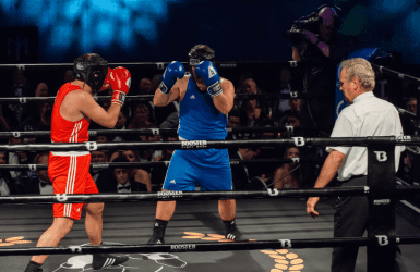 Two men wearing boxing gloves in a boxing ring