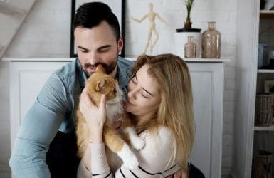 couple with cat in a domestic setting