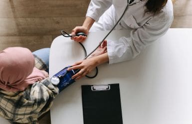 doctor measures blood pressure on patient