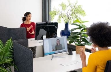 Two sign language interpreters at the computer