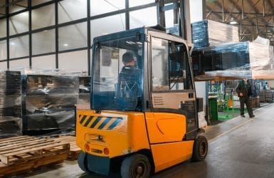 Man in forklift in warehouse