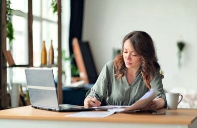 woman with laptop fills out documents