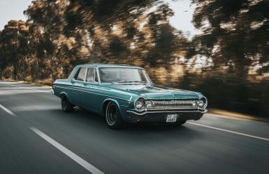 blue vintage car on the road